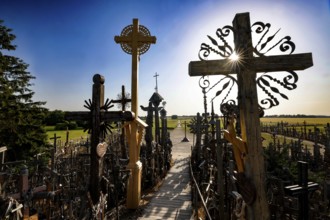 Path through the crosses in evening light on the Hill of Crosses in Siauliai, Siauliai, Lithuania