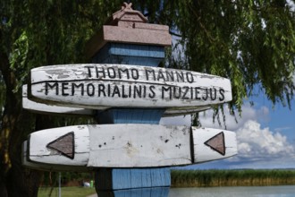 Wooden sign for the Thomas Mann Museum in Nida in front of a tree backdrop, Nida, Lithuania