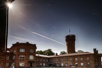 The historic Raudonn Castle with its distinctive tower under clear skies, Raudonn, Lithuania