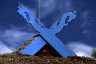 Blue wooden symbol on the pediment of the Thomas Mann House under a clear sky, Nida, Curonian Spit,