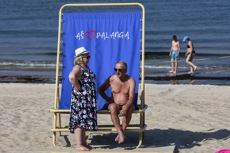 Two bathers on a sun chair on Palanga beach, children in water, Palanga, null, Lithuania
