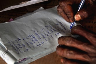 A person writes with a pen on paper in close-up, Mekele, Ethiopia