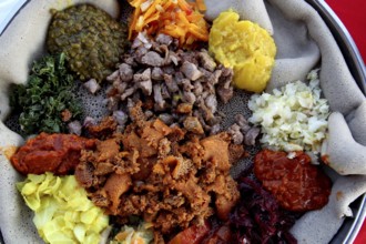 Diverse Ethiopian food platter with injera at Ben Abeba restaurant