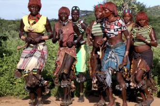 Hamer woman dance in traditional clothing during an initiation ritual. Vivid colors and traditional