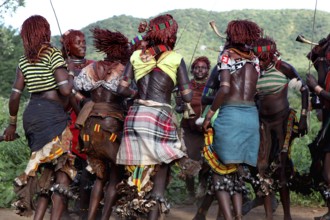 Hamer woman, wearing traditional clothes, dancing in circles, part of an initiation ritual, Turmi,