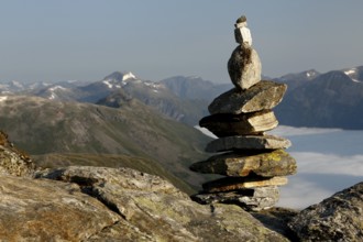 Stone pyramid on a mountain with a wide view over mountain ranges, Geirangerfjord, Dalsnibba,