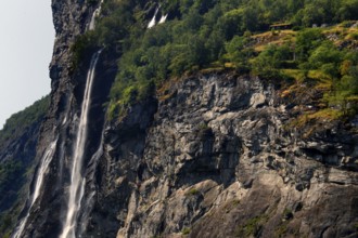 Fascinating rock wall with waterfall at Berghof in Geirangerfjord, Geirangerfjord, Møre og Romsdal,