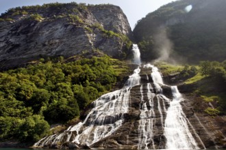 Impressive waterfall in Geirangerfjord, flowing over green cliffs, Geirangerfjord, Møre og Romsdal,