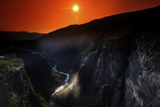 Spectacular view of Vøringsfossen at sunset in Måbødal, surrounded by dramatic rock faces,