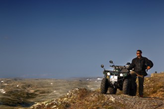 Adventurous ATV ride through the vast, barren mountains of Aurlandsfjell, Aurlandsfjell, Norway