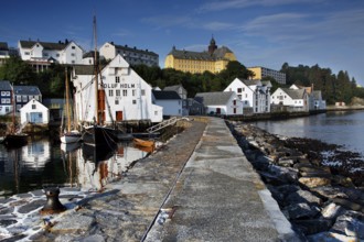 Wooden walkway at the fishing museum in Ålesund with picturesque coastal buildings, Ålesund, Norway