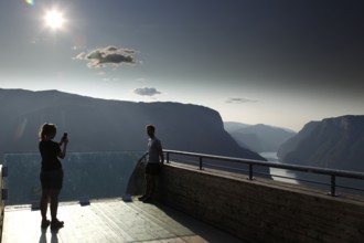 People enjoy the view of the fjord from the Stegastein platform, Aurlandsvangen, Norway