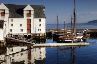 Fishing museum in Ålesund with traditional boats and calm seas, Ålesund, Norway