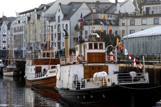 Boats in harbour in front of historic art nouveau buildings in Ålesund, Ålesund, Norway