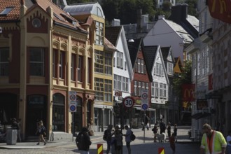 Scenic city view with historic colorful buildings and passers-by, Bergen, Hordaland, Norway