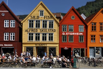 Cafes in front of the historic houses of Tyskebryggen in summer, Bergen, Norway
