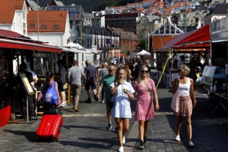 Lively scene at the fish market in Bergen with lots of people and stalls, Bergen, Norway