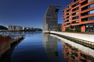 The Munch Museum is reflected in the clear water of Bjøvika in Oslo, Oslo, Bjøvika, Norway