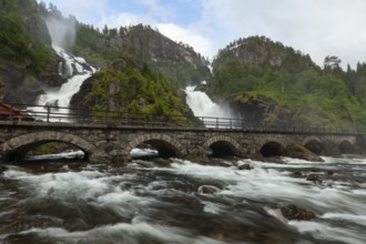 Summer day visiting Låtefossen falls near Odda, flowing water and green valley, Vestland, Norway