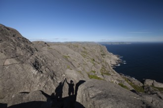 Shadow of two people giving a high five on a hiking trail view. Summer, Sandvika (Sandviga), Agder,