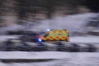 Ambulance on a road, winter, Germany