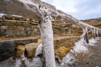Salt covering the wooden structures and ground in the historic salt valley of anana, showcasing the