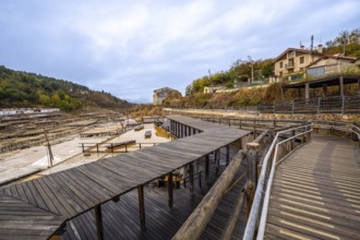 Anana salt valley showcasing traditional salt evaporation ponds, wooden structures, and a