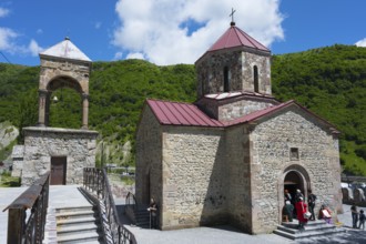 Stone church with bell tower against green landscape and blue sky, Kvemo Mleta Lomis dome church,