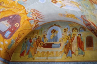 Vivid frescoes in a church depict biblical scenes with angels and saints in bright colors, domed