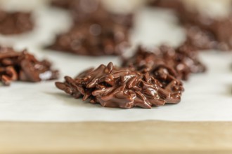 Fresh homemade almond pieces with dark chocolate on baking paper