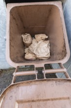 Full brown organic waste bin for food disposal. Germany