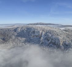 Aerial view of snowy stone walls and fog in the valley, Schwarzensee, Weissenbach an der Triesting,