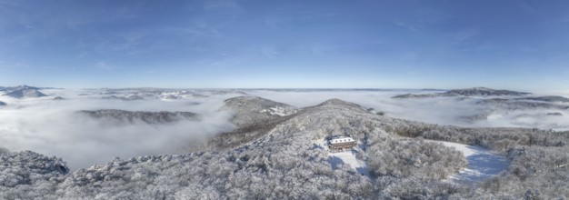 Aerial view of snowy stone walls with shelter and fog in the valley, Schwarzensee, Weissenbach an