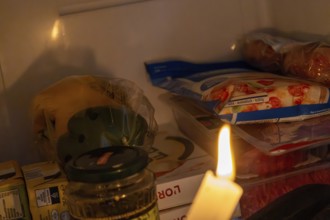 Blackout icon: Illuminating a dark refrigerator with a candle