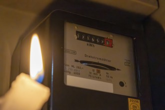 Blackout symbol image: Illuminating a distribution box with a candle