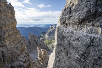 View from the Bocca degli Armi gap, mountaineers on a rock band on the Via Ferrata Bocciere