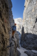 Climbers on the Via Ferrata Bocciere Centrale via ferrata, spectacular mountain landscape with