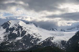 Mountain peak with Worthington Glacier glacier, dramatic cloudy sky, picturesque landscape on