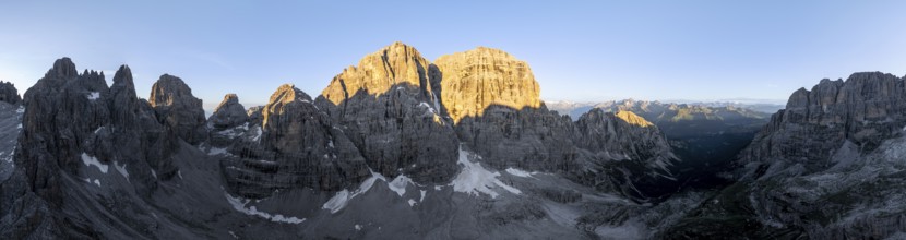 Aerial view, alpine panorama, Cima Tosa and rocky peaks at sunrise with alpine glow, picturesque