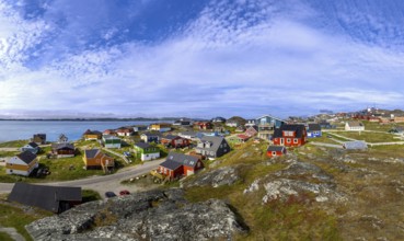 Typical architecture of Greenland Ilulissat with colored houses located near fjords and icebergs