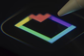 Dhaka, Bangladesh- 06 Dec 2025: Close-up of the GIPHY app on a screen with a stylus pointing at it