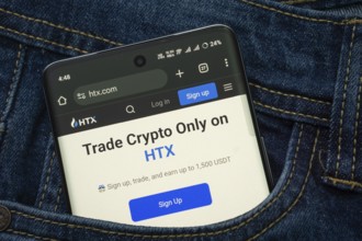 Dhaka, Bangladesh- 15 June 2025: A smartphone displaying the HTX web interface peeks out of a denim