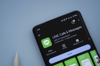 Dhaka, Bangladesh- 29 May 2025: On a blue surface, a smartphone displays the LINE app within the