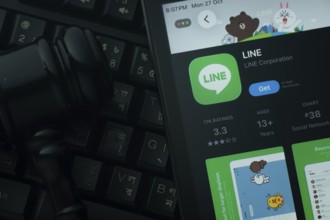 Dhaka, Bangladesh- 28 Oct 2025: An iPad displaying the LINE app against a judge's gavel and dark