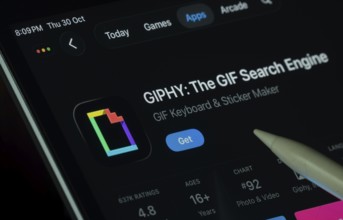 Dhaka, Bangladesh- 30 Oct 2025: GIPHY app displayed on a iPad screen in dark mode with a digital