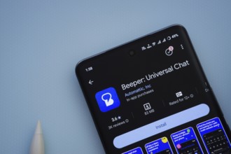 Dhaka, Bangladesh- 29 May 2025: On a blue surface, a smartphone displays the Beeper app within the