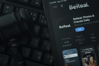 Dhaka, Bangladesh- 28 Oct 2025: An iPad displaying the BeReal app against a judge's gavel and dark