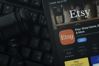 Dhaka, Bangladesh- 28 Oct 2025: An iPad displaying the Etsy app against a judge's gavel and dark