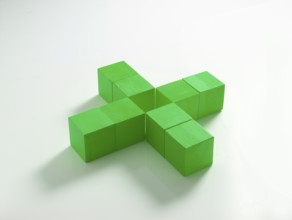 8 green wooden cubes against a white background