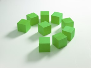 9 green wooden cubes against a white background